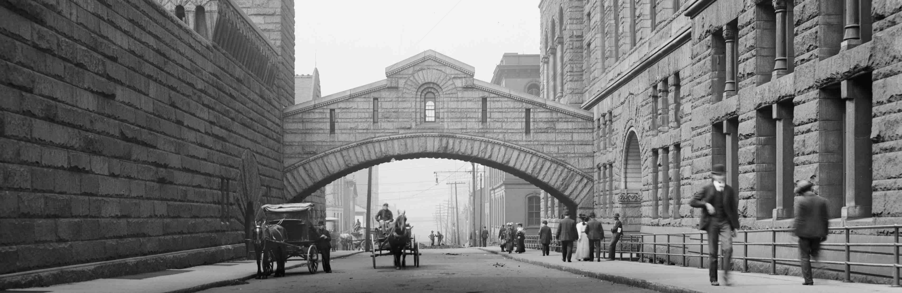 Allegheny county courthouse and jail on right and left side of bridge.